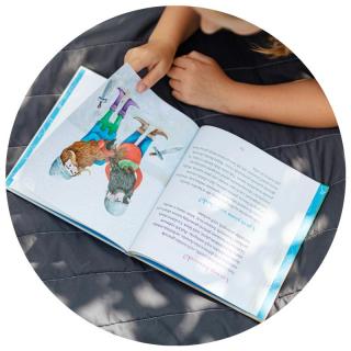Mädchen mit Bilderbuch. Link zu unserem Onlineschaufenster Bücher für kleine Bücherwürmer.